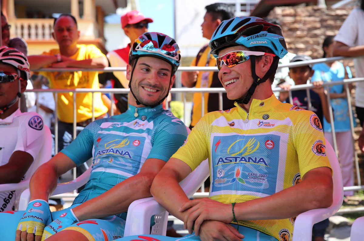 Astana teammates Andrea Guardini and Miguel Lopez relax before the stage start