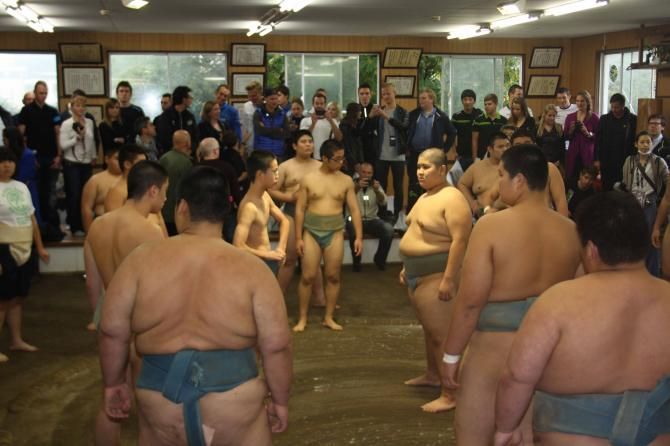 The Saitama Criterium peloton observes a sumo exhibition on the eve of the race.