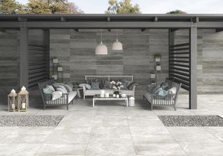 large grey porcelain tiles leading to outdoor seating area with pergola