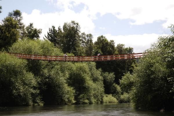 Two racers cross a high bridge.