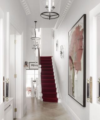 White staircase, red carpet, glass lights