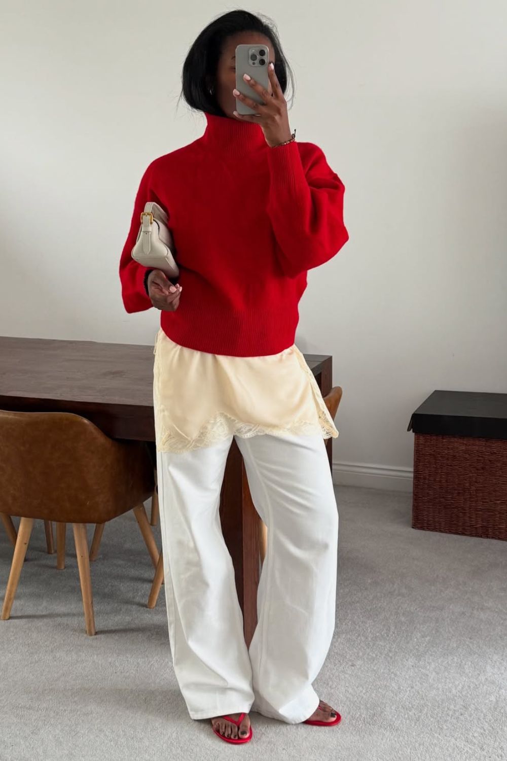 Marilyn NK wears white jeans and a red jumper