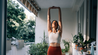 Woman stretching her body on terrace