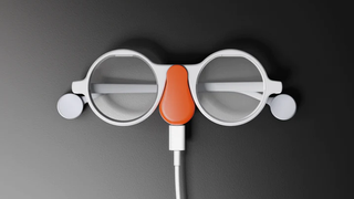 A picture of the Frame AI glasses with their Mister Power charger