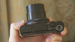 Sony Cybershot RX100 point-and-shoot camera in the hand