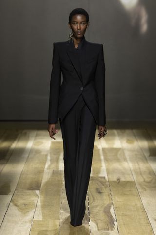 Woman in Alexander McQueen black suit