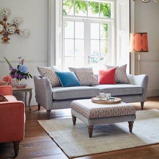 Grey sofa with floral patterned sides in living room