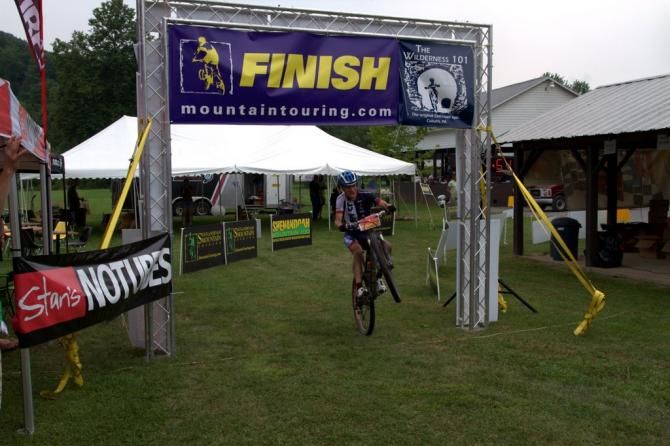 Christian Tanguy (Team CF) styles it with a wheelie across the line