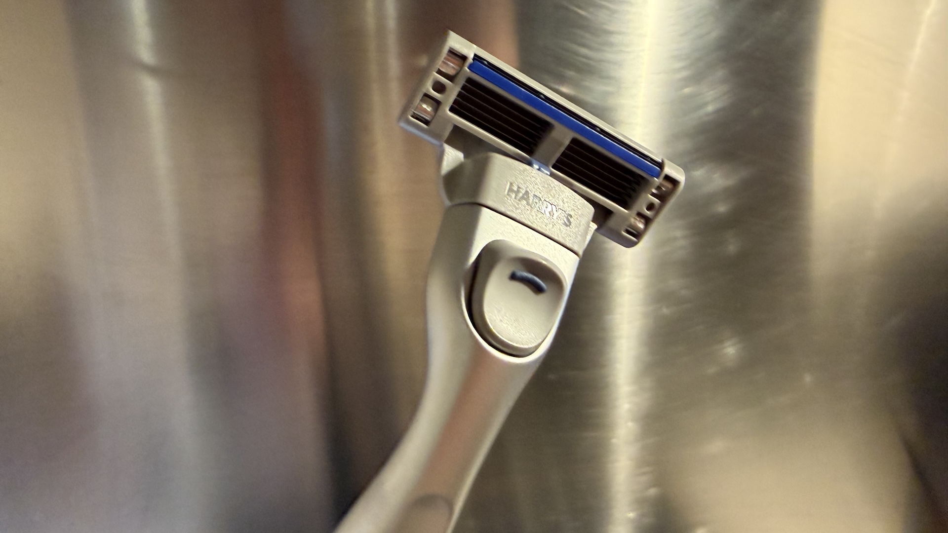 The Harry&#039;s Plus Razor against a stainless steel background