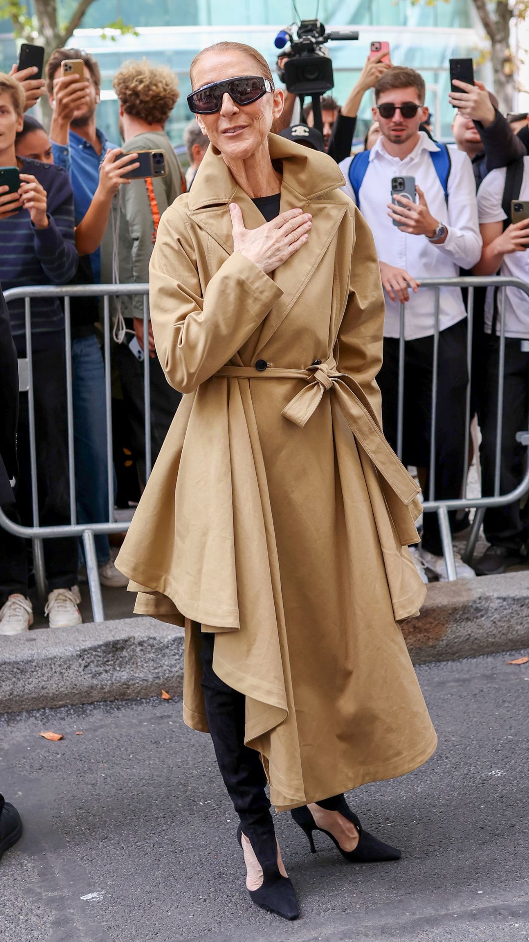 celine dion wearing a trench coat and boots
