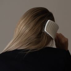 Photo of a woman brushing her hair