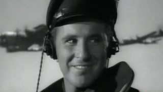 Bob Dornan in a pilot uniform, flying a plane in 12 O'Clock High