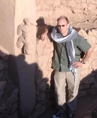 The reliefs at Gobekli Tepe were carved more than 11,000 years ago on giant limestone blocks. Professor Tristan Carter is seen here beside an image of a creature, possibly a reptile.