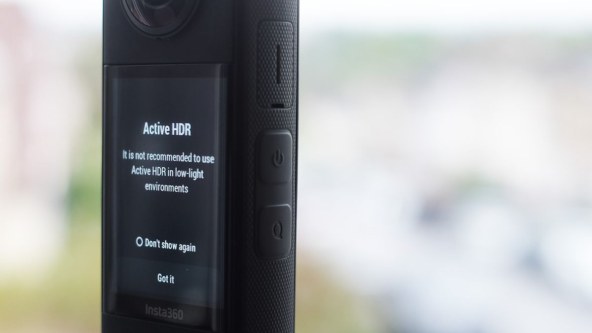 Insta360 X3 on a plynth closeup with blurred cityscape background