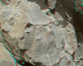 This stereo view of Mars rock by NASA's Curiosity rover shows small hollows that have a "swallowtail" shape similar to that of gypsum crystals on Earth. NASA scientists say the features were formed by crystals that later dissolved away.