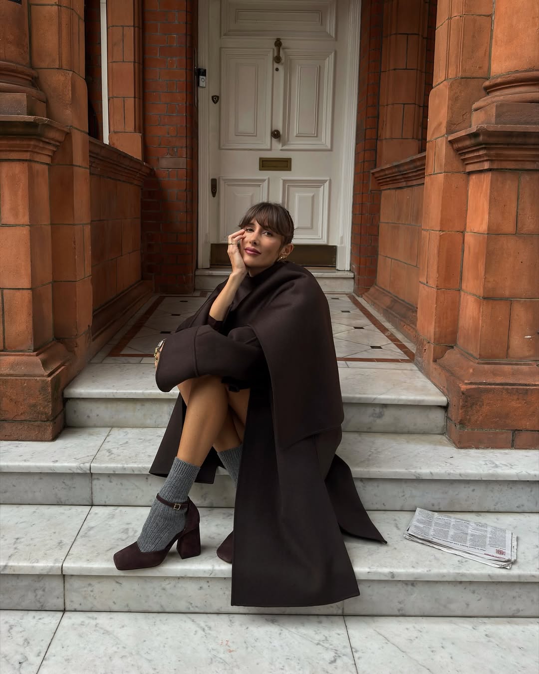 Julie Sergent Ferreri wears a brown coat and mini dress