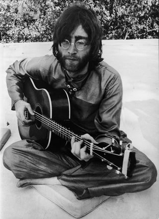 John Lennon pictured in India in 1968 playing Donovan's Gibson J-45