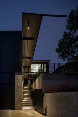 outdoors staircase leading up to a house illuminated at night