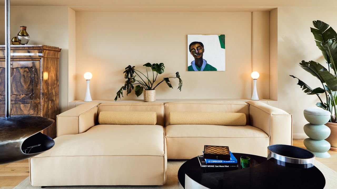 Living room with warm beige walls, butter yellow sofa and pale blue side table