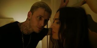 Machine Gun Kelly stares down a pinned Megan Fox in Midnight in the Switchgrass.