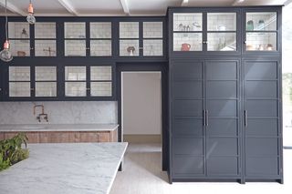 A kitchen with tall storage unit