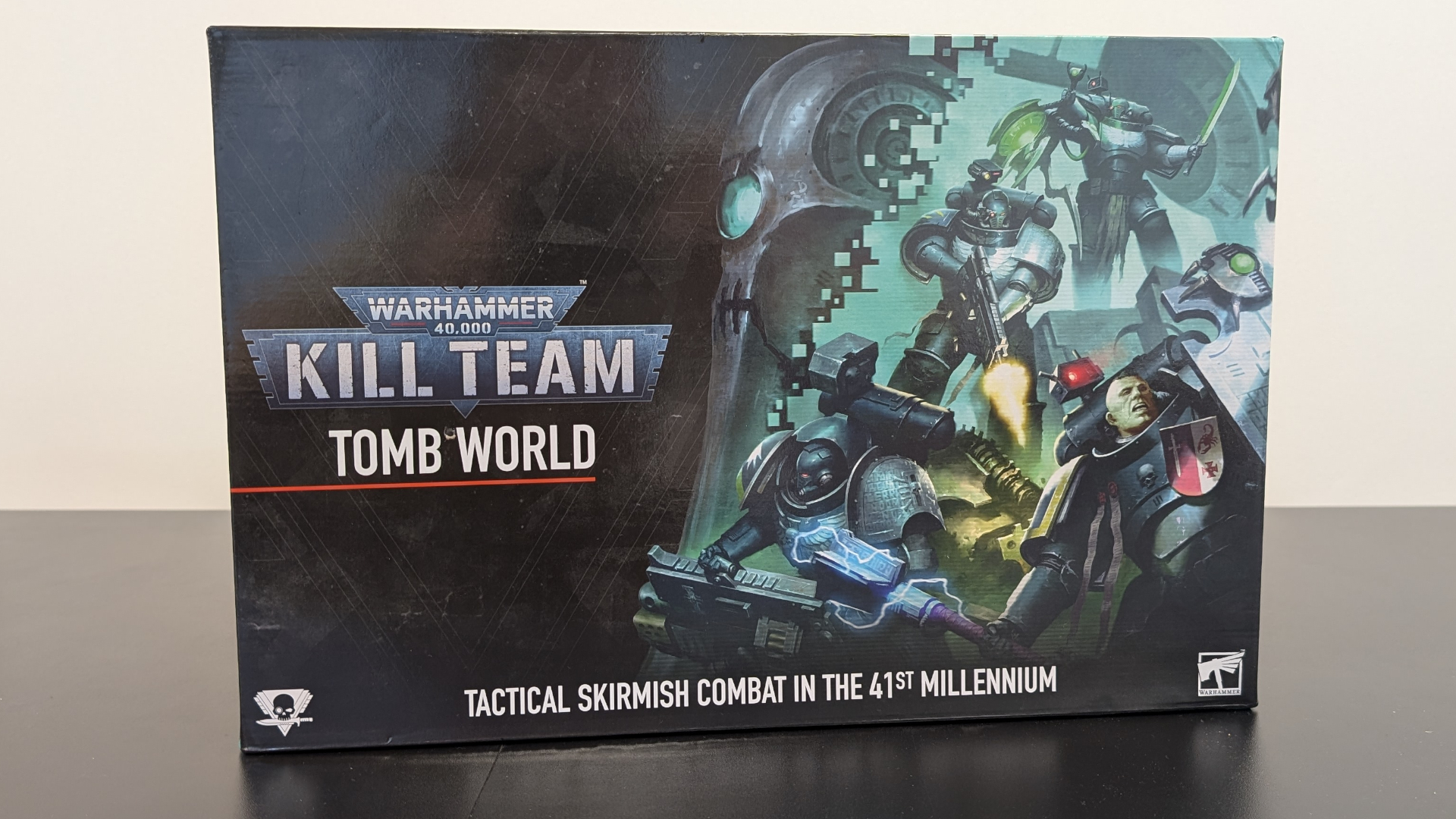 Kill Team: Tomb World box on a dark surface, against a plain background