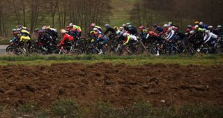 The pack of riders cycles during the 5th stage of the Paris-Nice cycling race, 196,5 km between Saint-Just-en-Chevalet and La CÃ´te-Saint-AndrÃ©, on March 13, 2025. (Photo by Anne-Christine POUJOULAT / AFP)