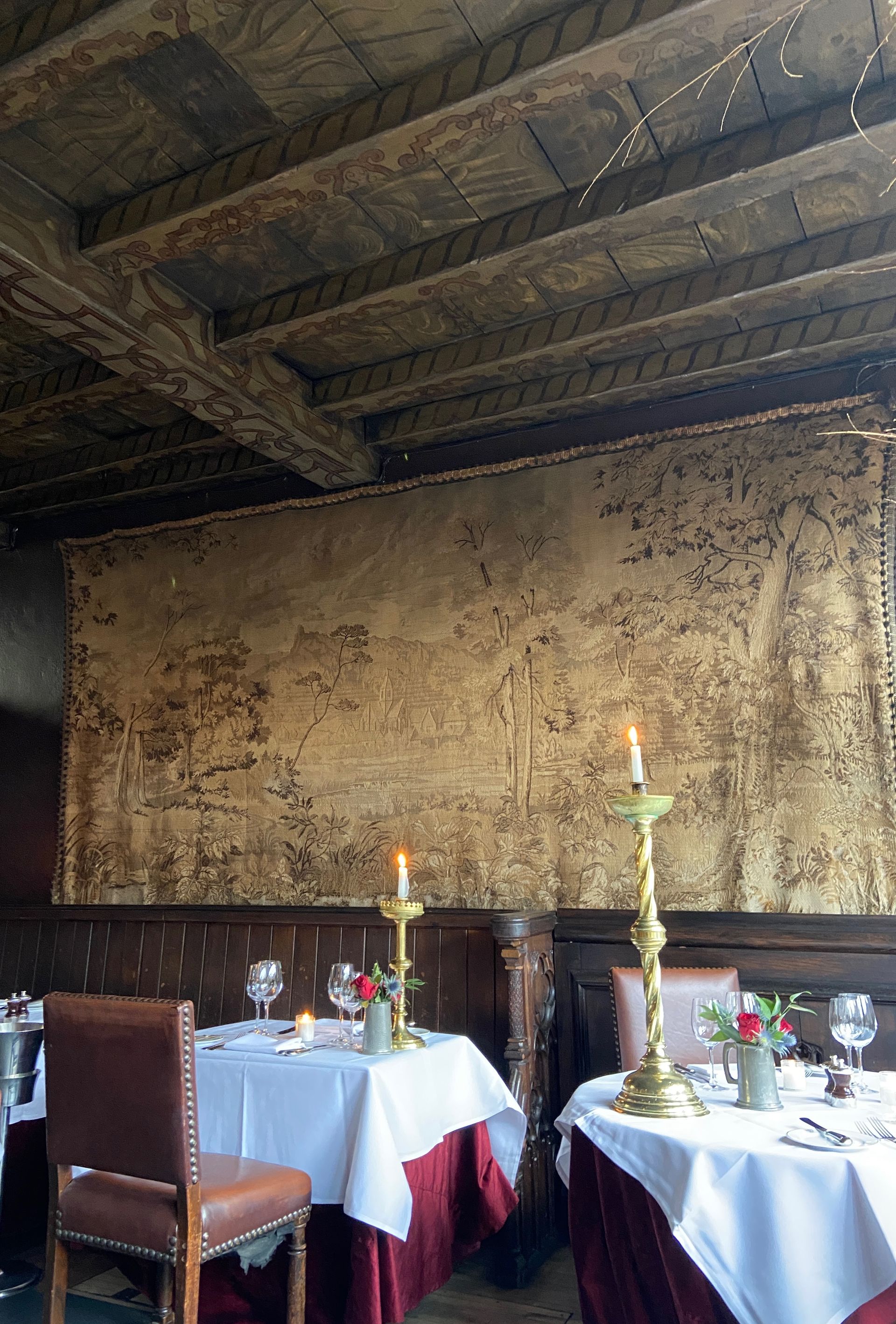 A tapestry on the wall and candlesticks at The Witchery in Edinburgh