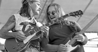 Dickey Betts [left] and Warren Haynes trade licks onstage with the Allman Brothers Band at the 1993 New Orleans Jazz & Heritage Festival. Haynes's Strat would soon be stolen in New York.