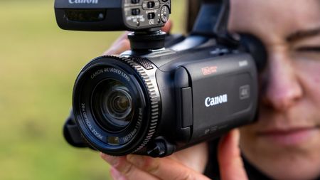 A female filmmaker holding the Canon XA65