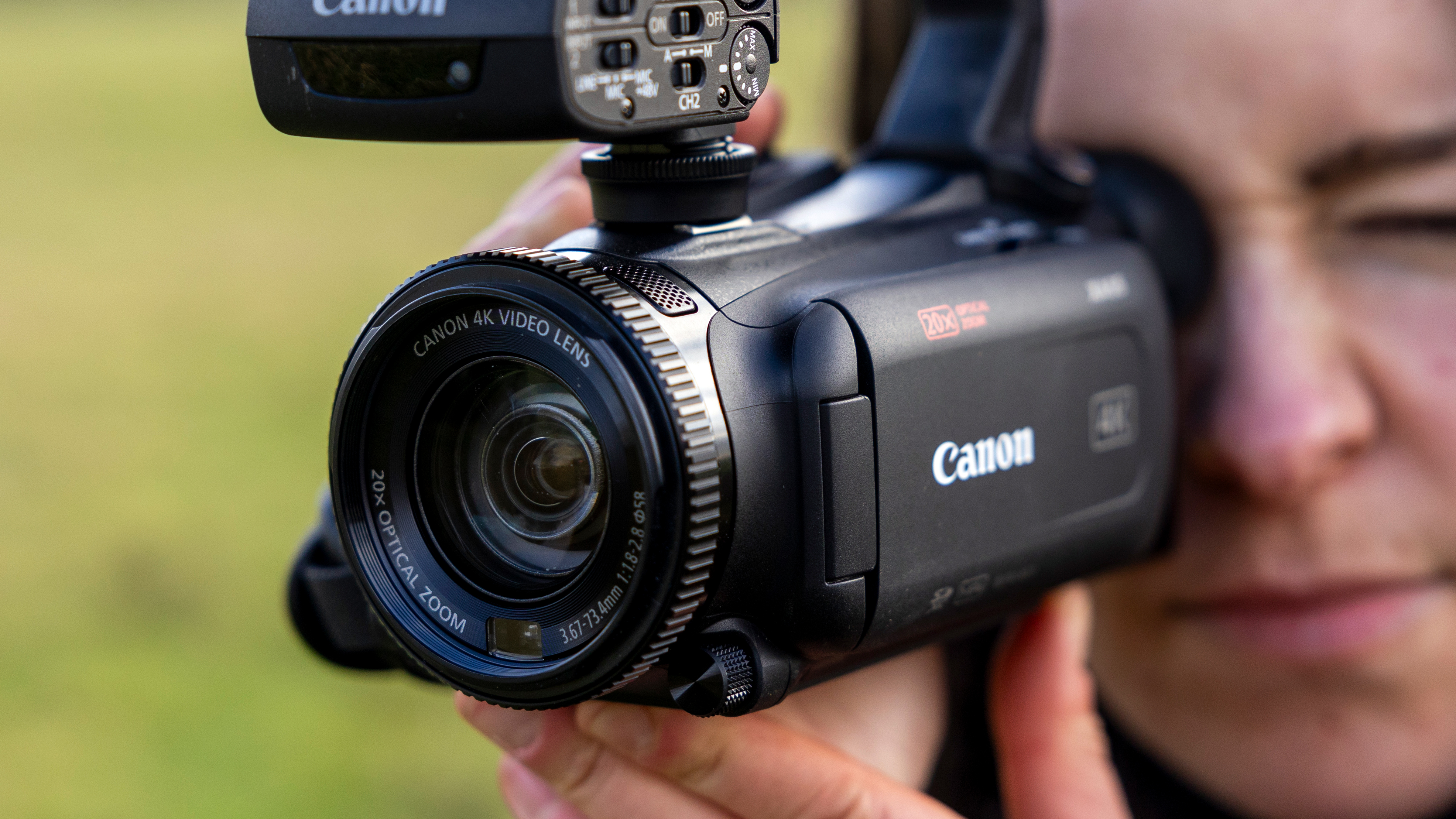 A female filmmaker holding the Canon XA65