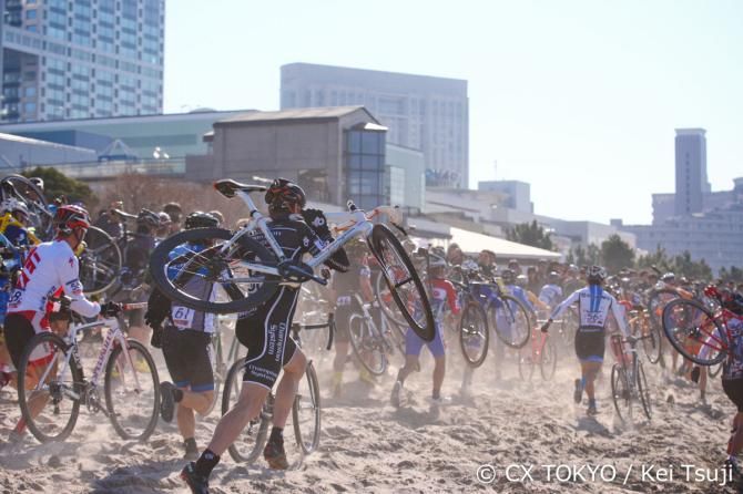 Riders run through the sand