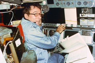 STS-1 commander John Young at the controls aboard space shuttle Columbia during the first mission of NASA’s winged orbiter program.