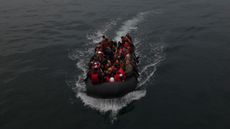 A boat carrying migrants drifts into English waters after crossing the Channel from the French coastline 
