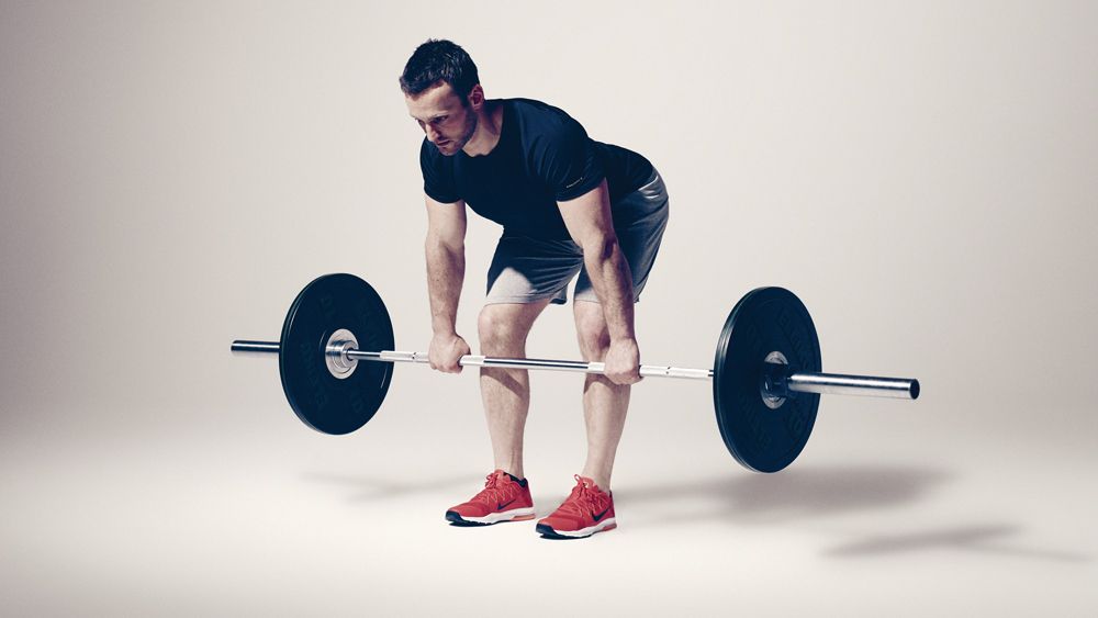 Romanian deadlift, demonstrated by a man holding a barbell just below his knees