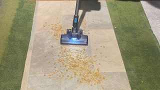 Hoover Blade+ vacuuming cereals off linoleum floor