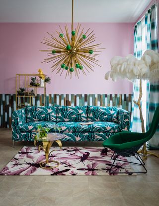 Pink Maximimalist living room with pattern sofa, rug and starburst light