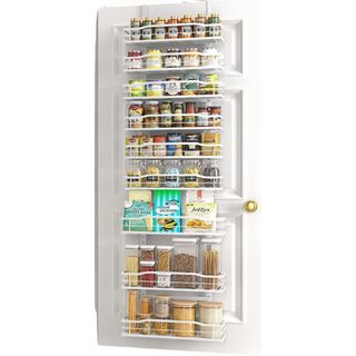 A white over the door storage organizer over a white door filled with pantry products