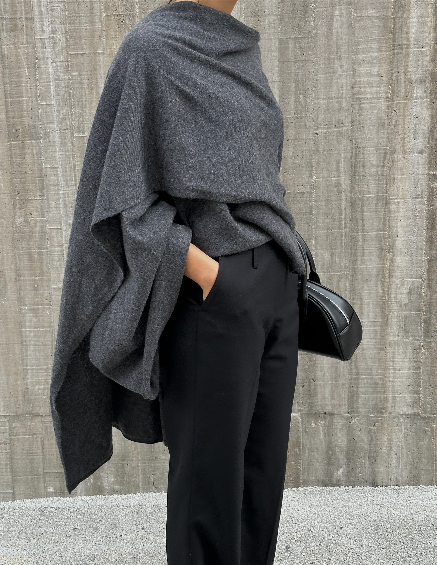 Influencer wearing scarf neckline trend top in gray.