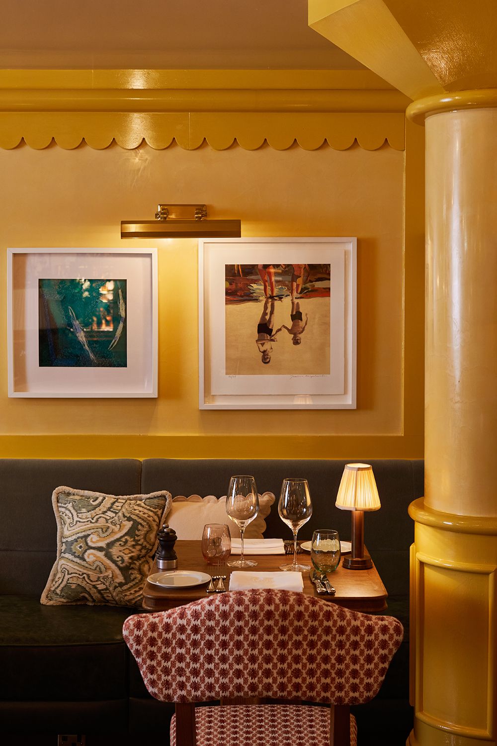 A dining table in a restaurant with glossy yellow walls