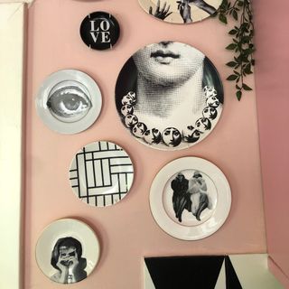 A plate gallery wall against a pink wall
