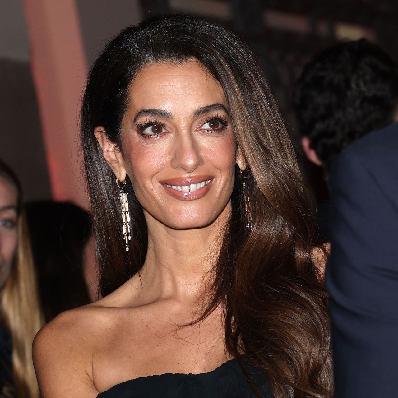 Amal Clooney wears a black dress to Omega House in Milan