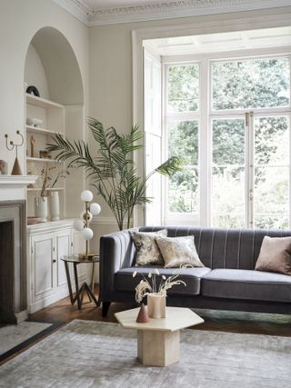 small living room with alcove cupboard and shelves