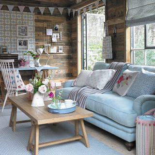wooden shed with blue sofa and table