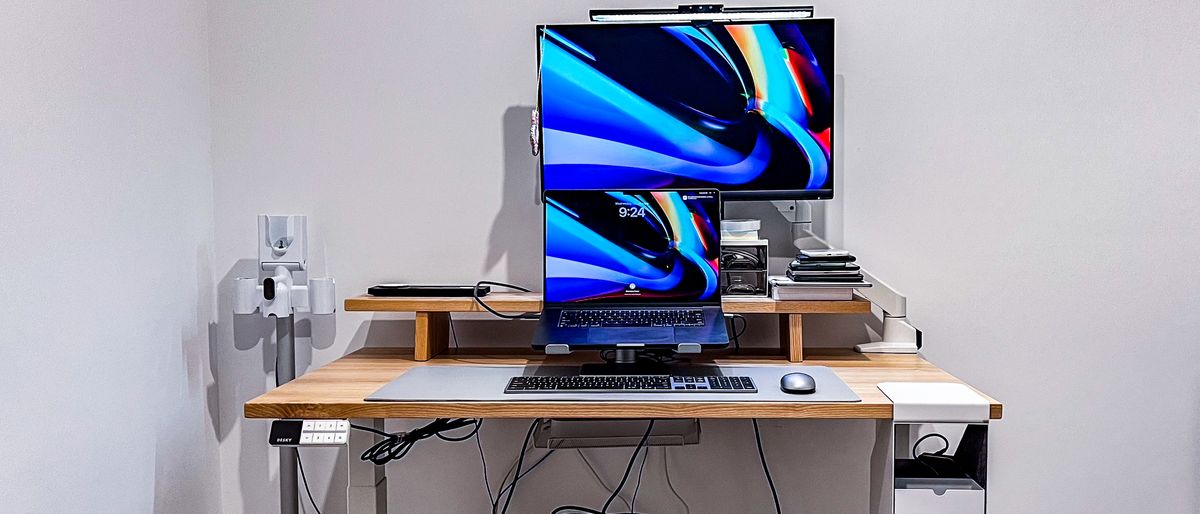 Desky Dual Bamboo standing desk fully set up with laptop and monitor