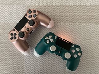 Rose Gold and Alpine Green DualShock 4 controllers with light bar on