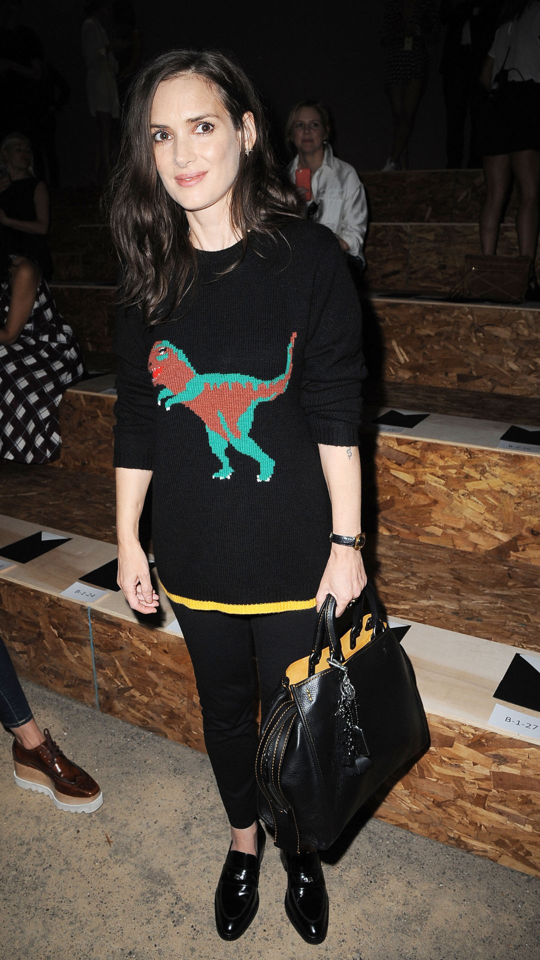 Winona Ryder wearing dinosaur graphic knit jumper at Coach Spring runway show in 2017