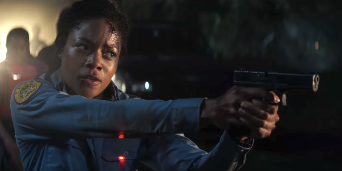 naomie harris black and blue bloody pointing gun