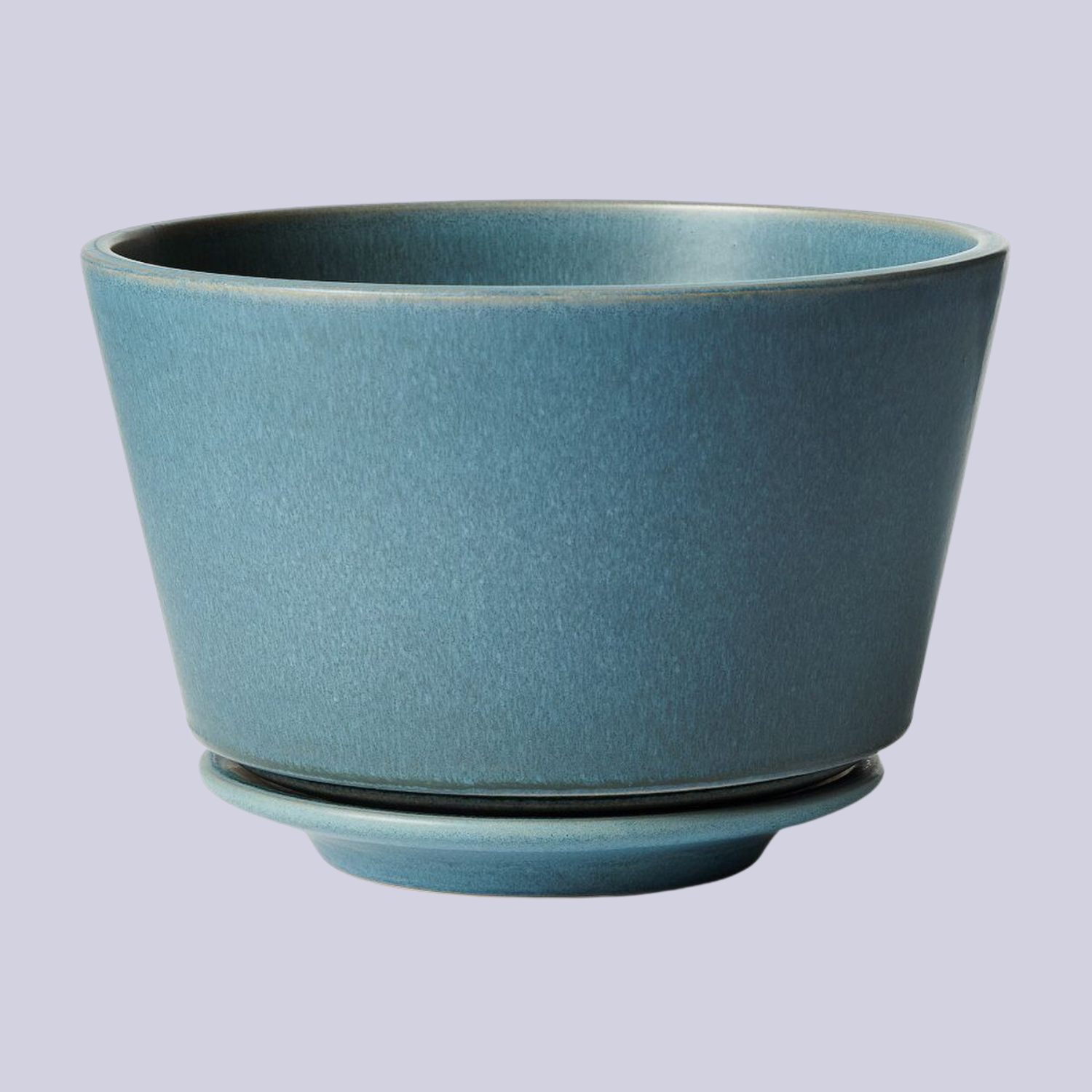 A teal planter with a saucer