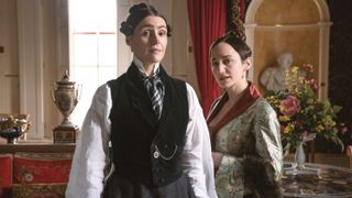 Suranne Jones in a white shirt and black waistcoat as Anne Lister in a grey wrap as Mariana Lawton in Gentleman Jack